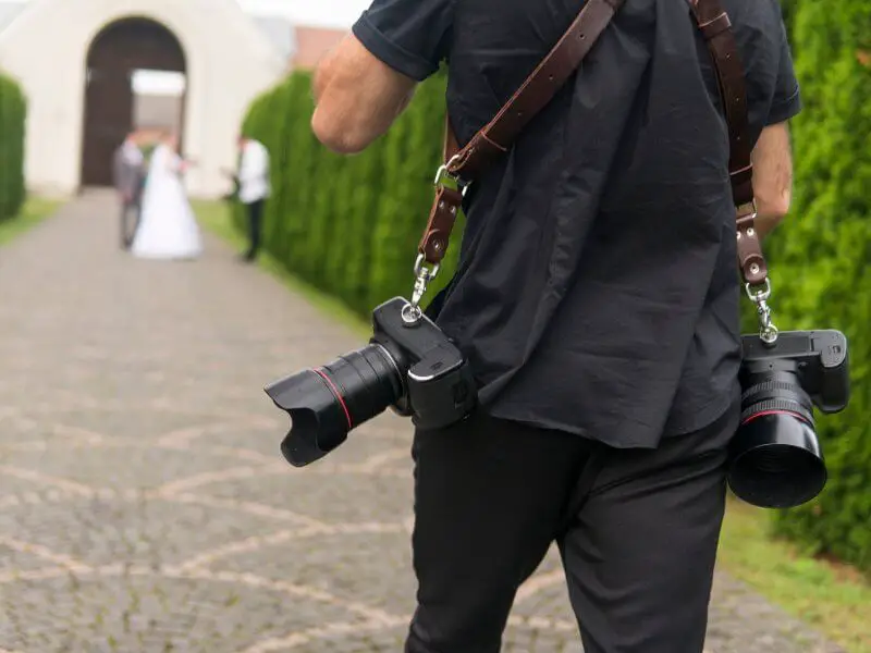 Wedding photographer with multiple cameras preparing for the photo shoot