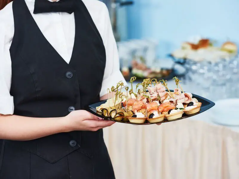 Wedding caterer staff carrying food to be served 
